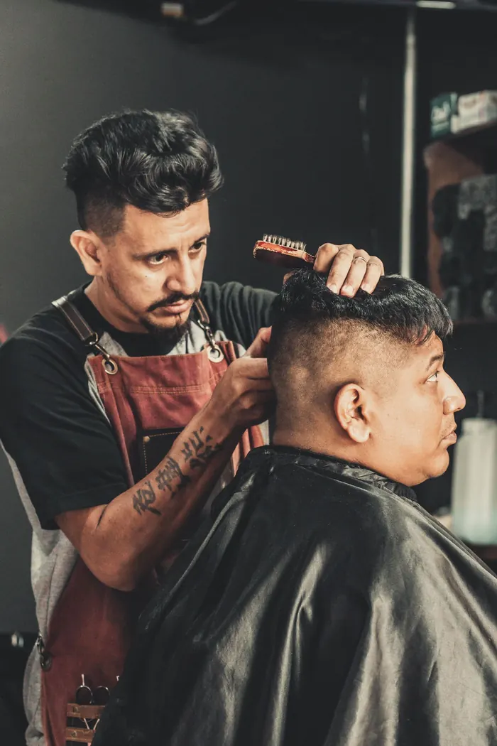 A barber cutting a customer's hair